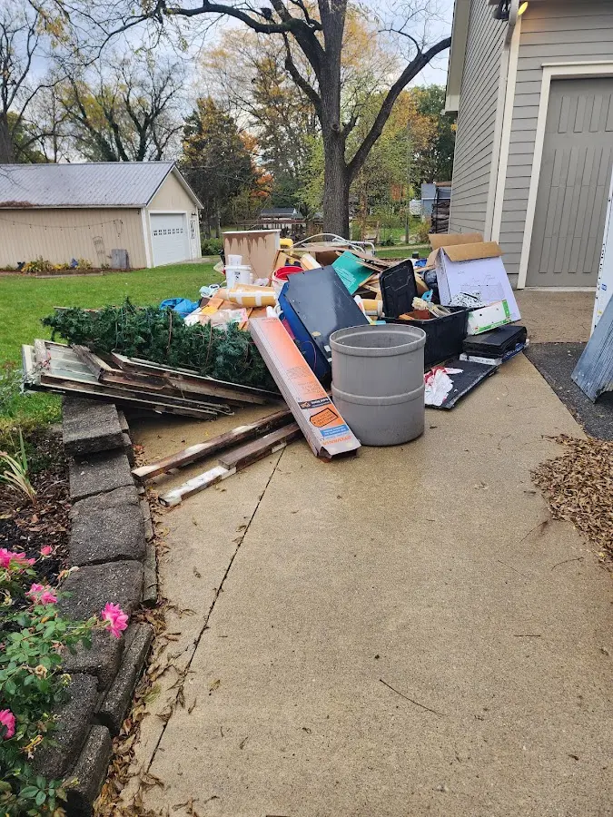 Dumpster being loaded with debris for 12 Yard Dumpster Rental in Capitol View